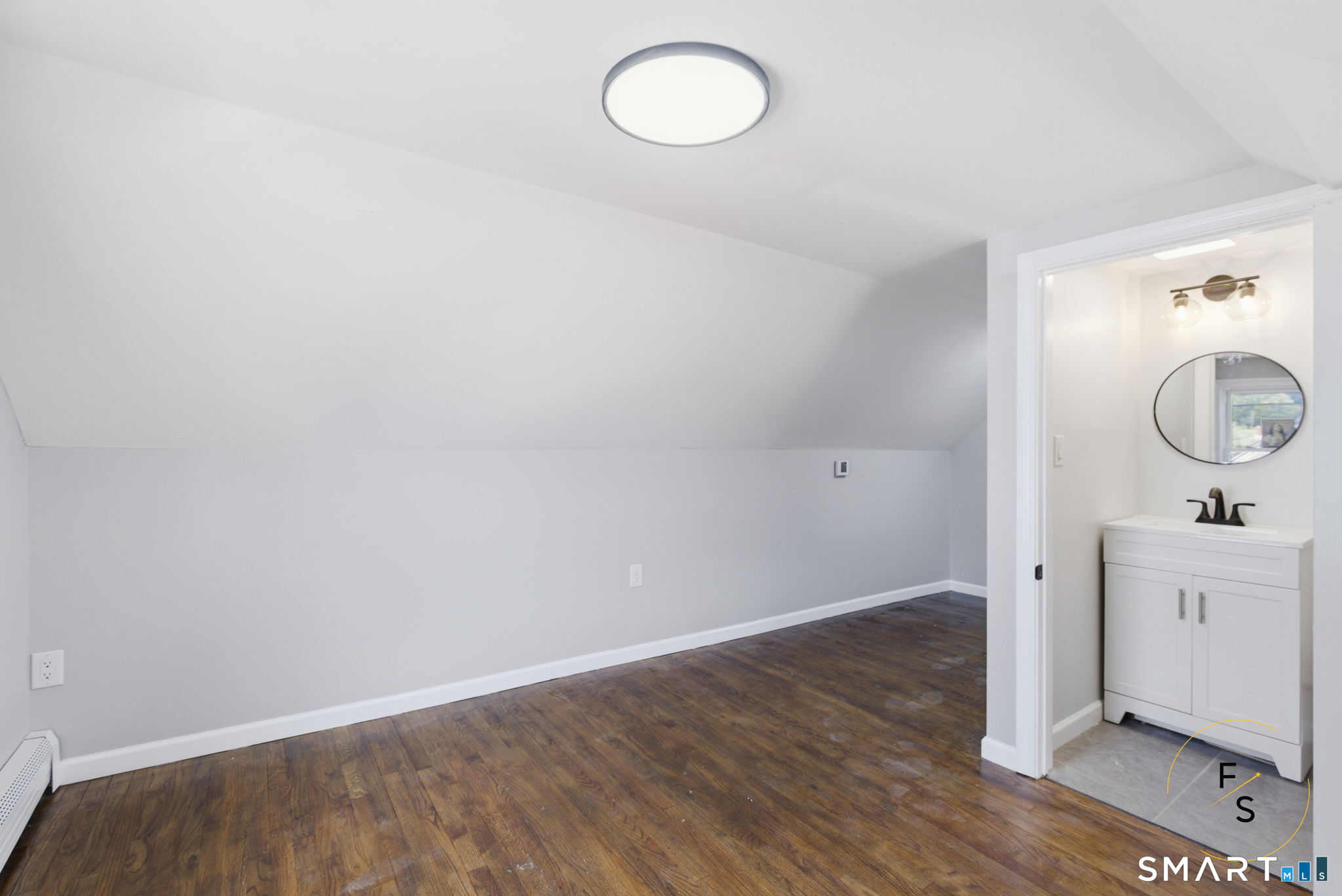 65 Broad Street Manchester, CT 06042 - Photo 26 of 40 an empty room with wooden floor and mirror