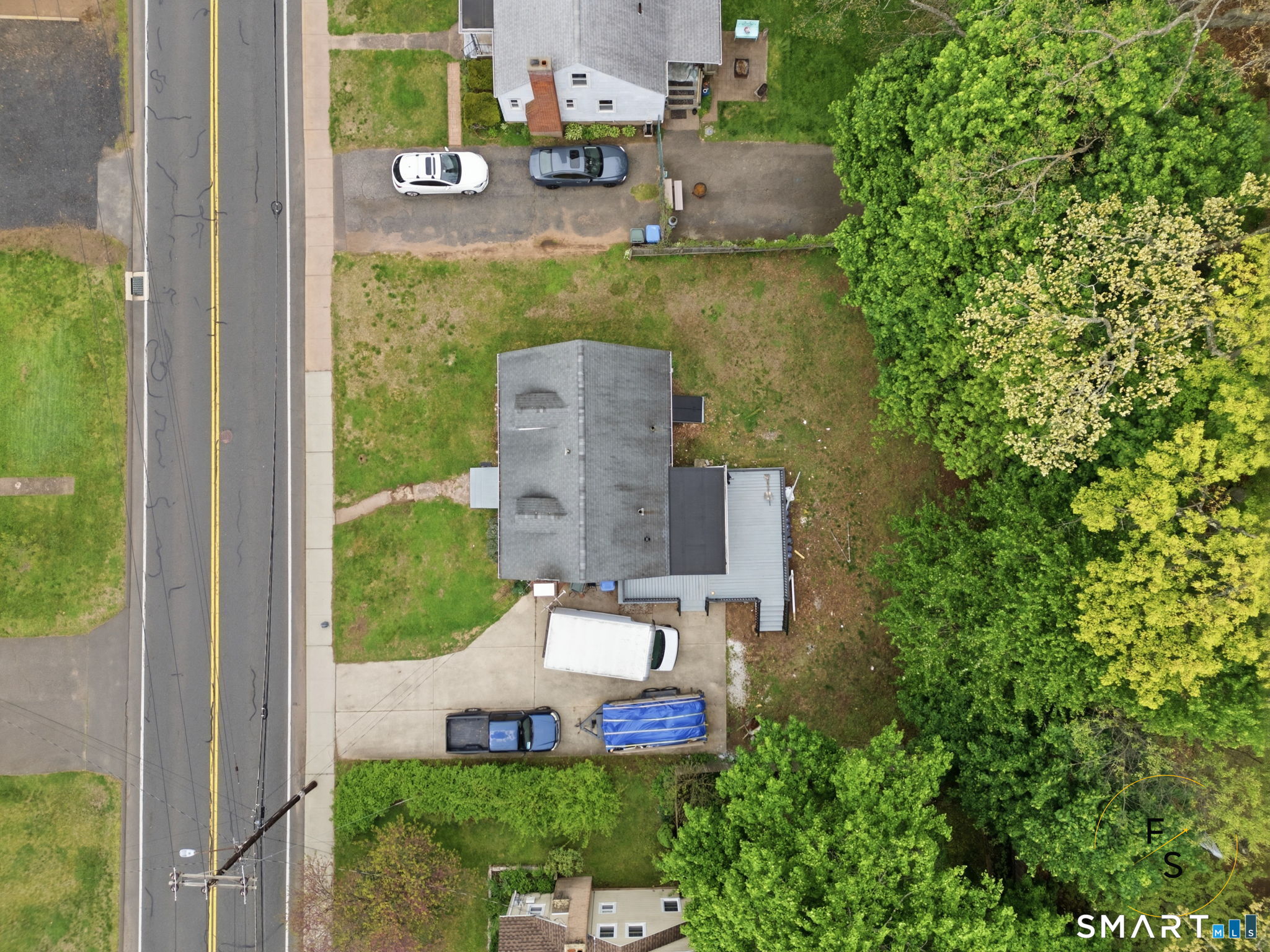 65 Broad Street Manchester, CT 06042 - Photo 36 of 40 an aerial view of a house with a garden and trees