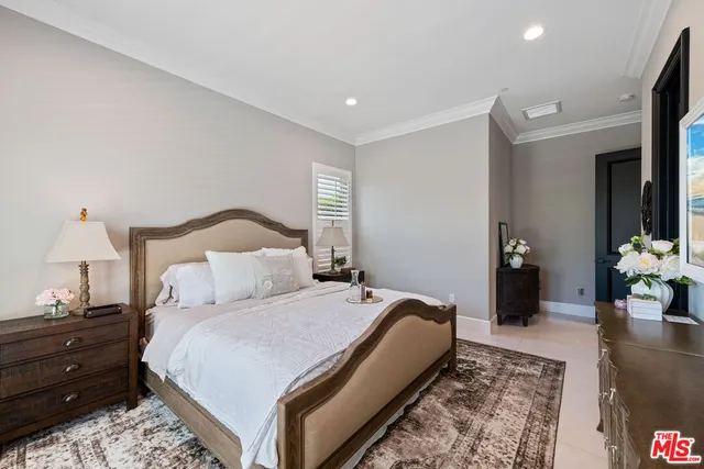 a bedroom with a bed and a lamp