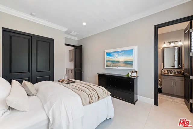 a bedroom with a bed and a chandelier