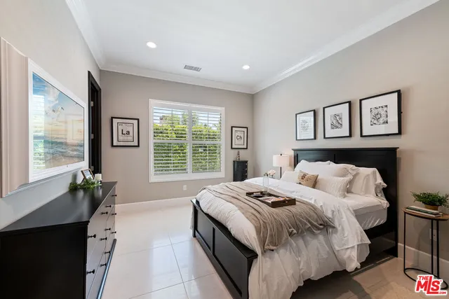 a bedroom with a large bed and a window