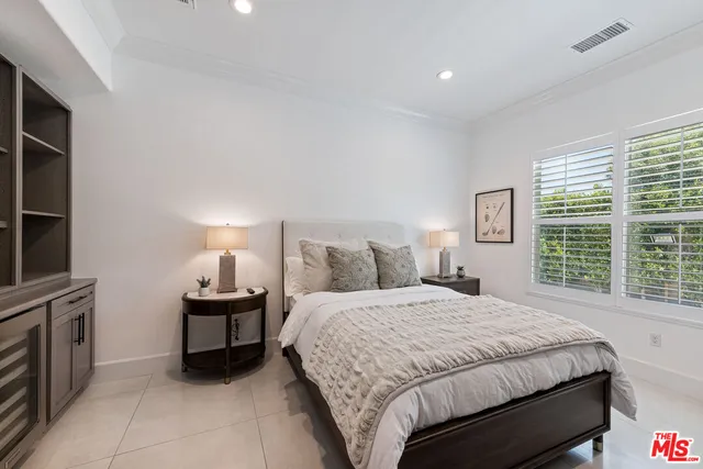 a bedroom with a bed lamps and window