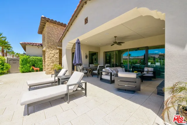 a building outdoor space with patio furniture and potted plants