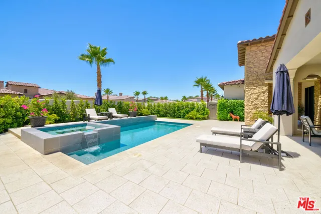 a view of a house with a yard and potted plants