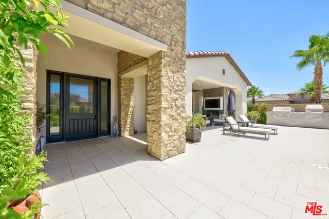 a view of a patio with table and chairs potted plants with sky view