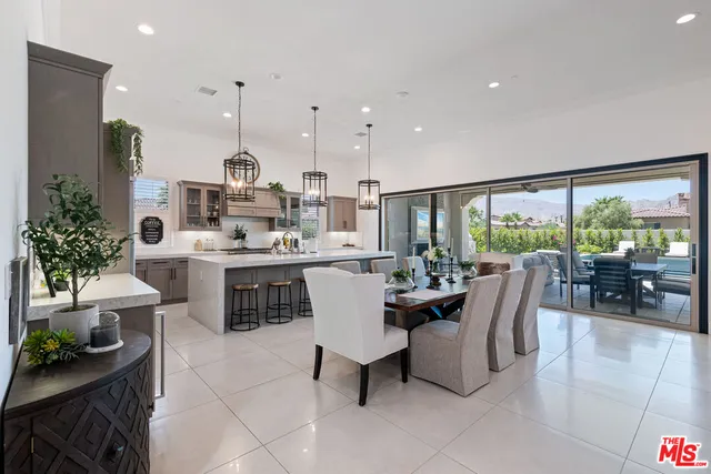 a dining room with furniture and a floor to ceiling window