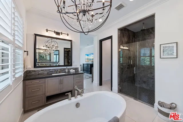 a bathroom with a tub sink and mirror
