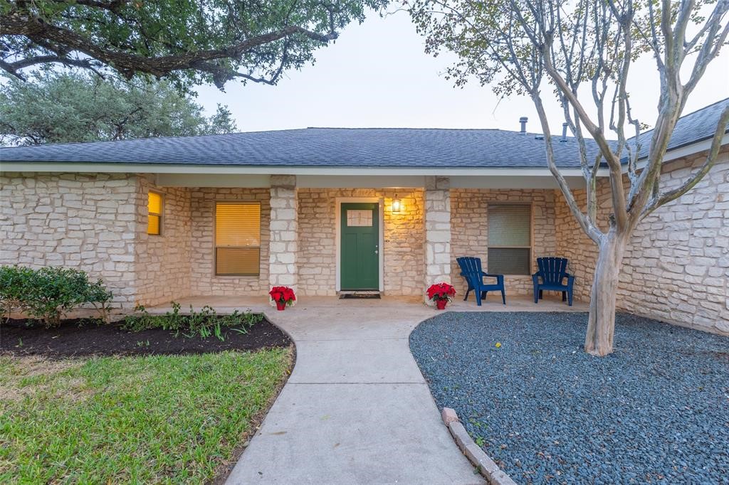 a front view of a house with a yard and outdoor seating