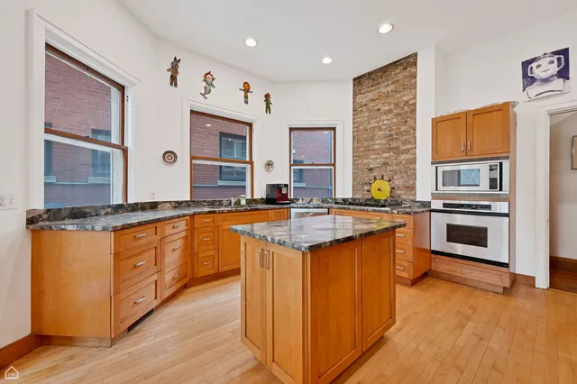 a kitchen with stainless steel appliances granite countertop a stove and a sink