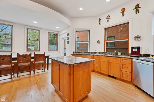 a large kitchen with lots of counter space and sink
