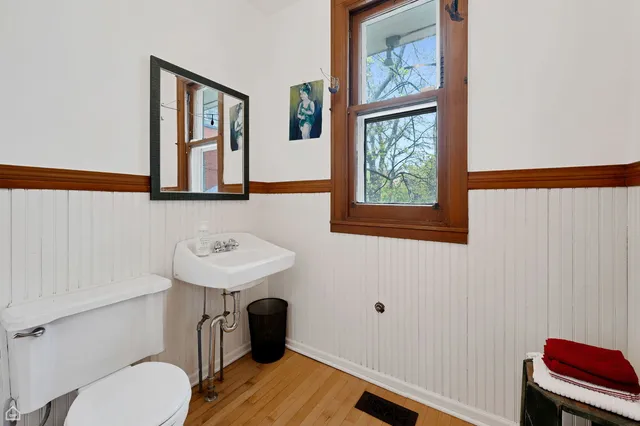 a bathroom with a sink a toilet and a window
