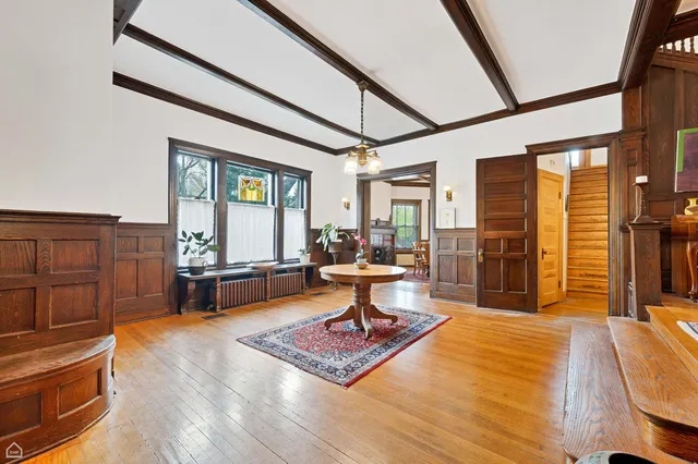 a living room with furniture a fireplace and large windows