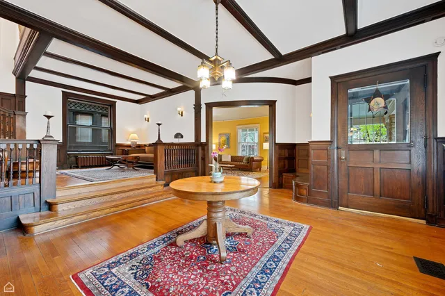 a living room with patio furniture and a chandelier