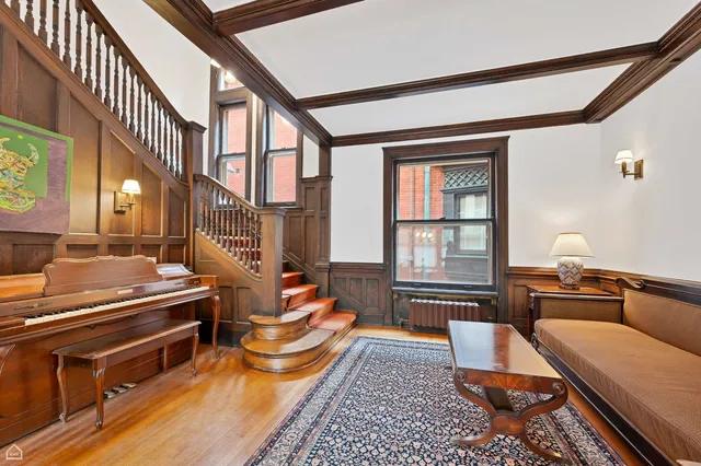 a living room with furniture fireplace and a window