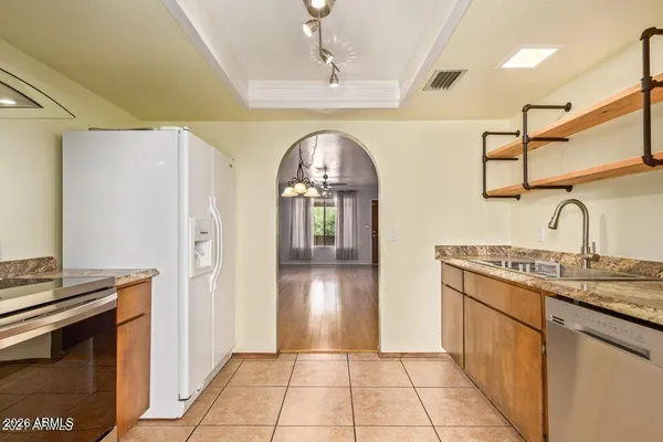 a hallway with sink and a refrigerator
