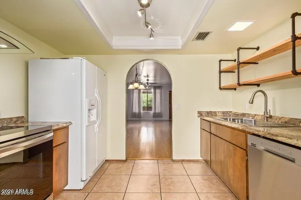 a hallway with sink and a refrigerator