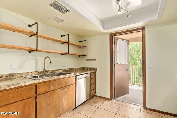 a kitchen with stainless steel appliances granite countertop a sink and a refrigerator
