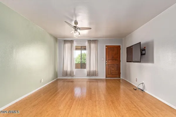 a view of livingroom with hardwood floor and ceiling fan