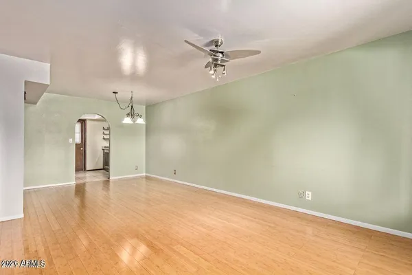 an empty room with a empty space and a ceiling fan