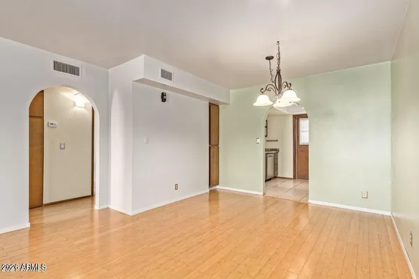 a view of a room with wooden floor closet and windows