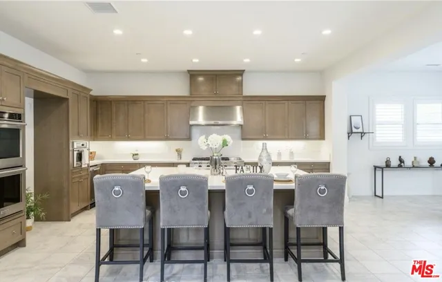 a kitchen that has a table and chairs in it