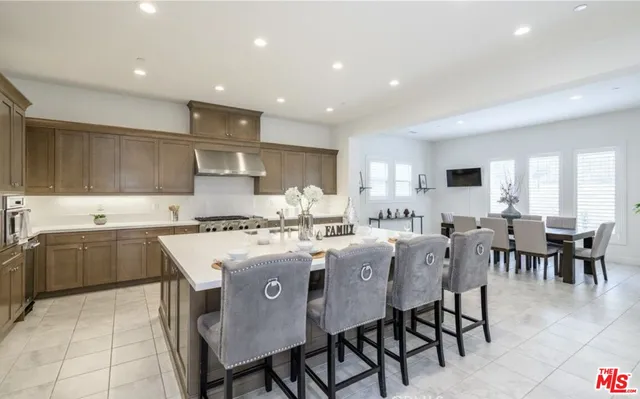 a kitchen with appliances a sink a counter top space and cabinets