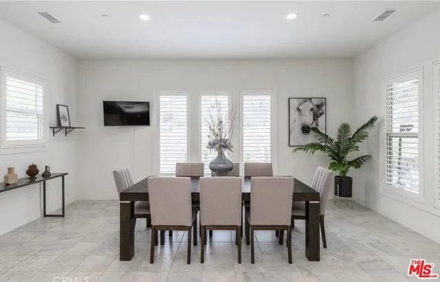 a view of a dining room with furniture and a window