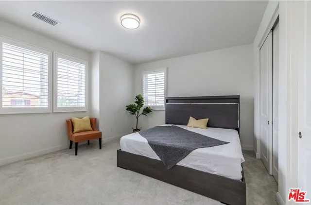 a bedroom with a bed and a couch