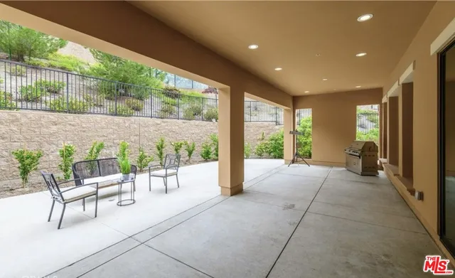 a view of a house with outdoor seating and a potted plant