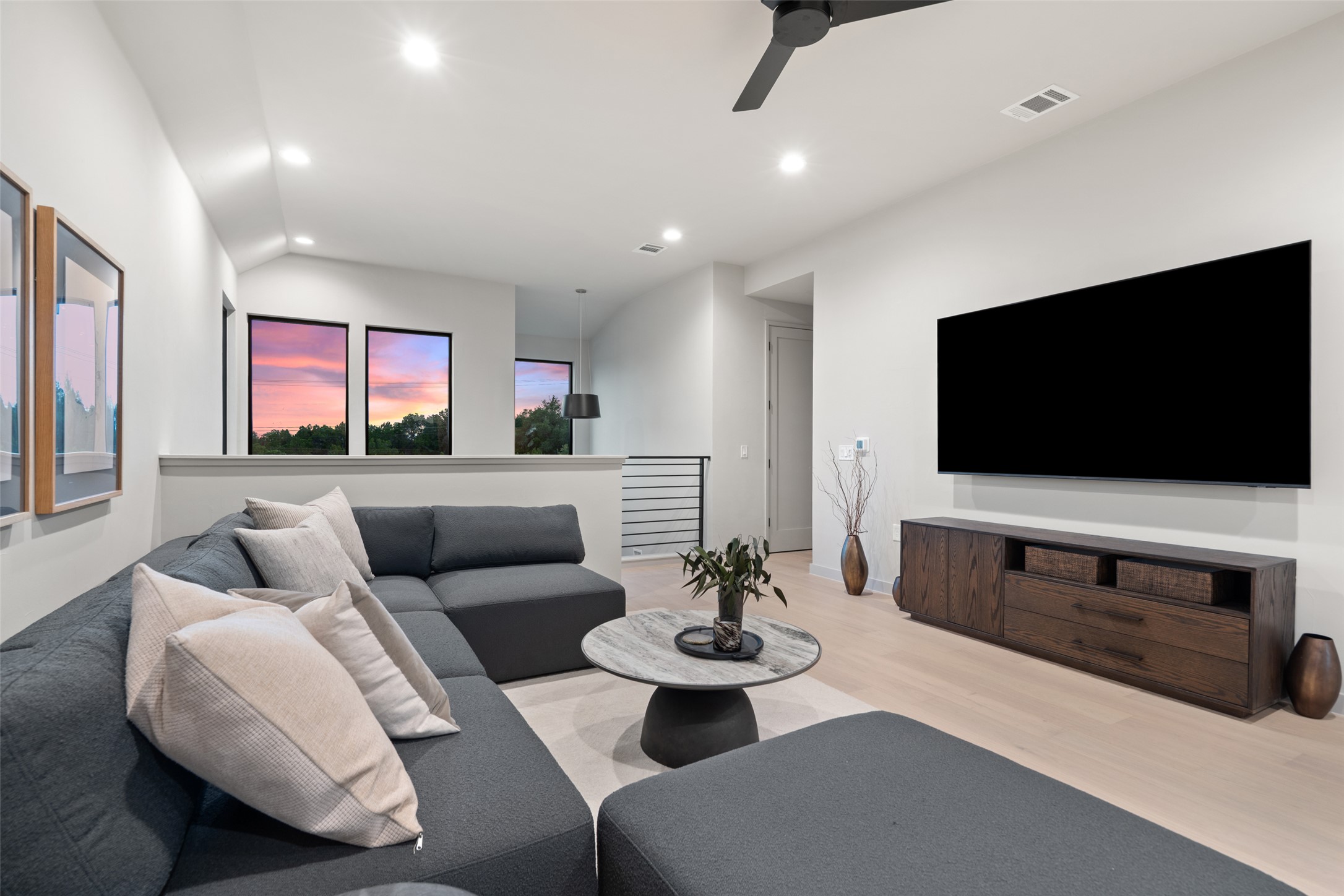 9803 Ribelin Ranch Court, Unit 6 Austin, TX 78750 - Photo 20 of 31 Sun-filled living area features soaring ceilings and light wood flooring.