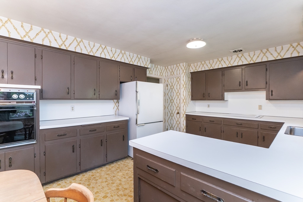 35 Squire Lane Springfield, MA 01118 - Photo 11 of 28 a kitchen with a sink a stove a refrigerator and cabinets