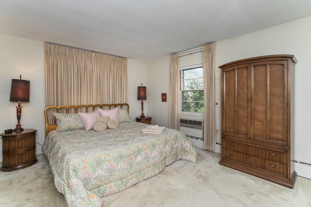 35 Squire Lane Springfield, MA 01118 - Photo 19 of 28 a large bed sitting in a bedroom next to a window and dresser