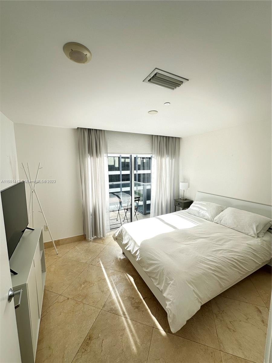 1060 Brickell Avenue, Unit 413 Miami, FL 33131 - Photo 7 of 13 a bedroom with a bed and a window