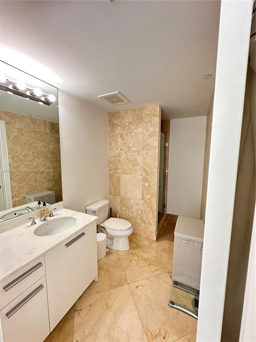 1060 Brickell Avenue, Unit 413 Miami, FL 33131 - Photo 9 of 13 a bathroom with a sink a toilet and shower