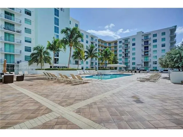 a swimming pool with outdoor seating and yard