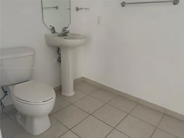a utility room with wooden floor washer and dryer