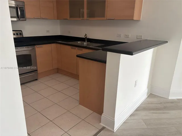 a kitchen with a sink and a stove top oven