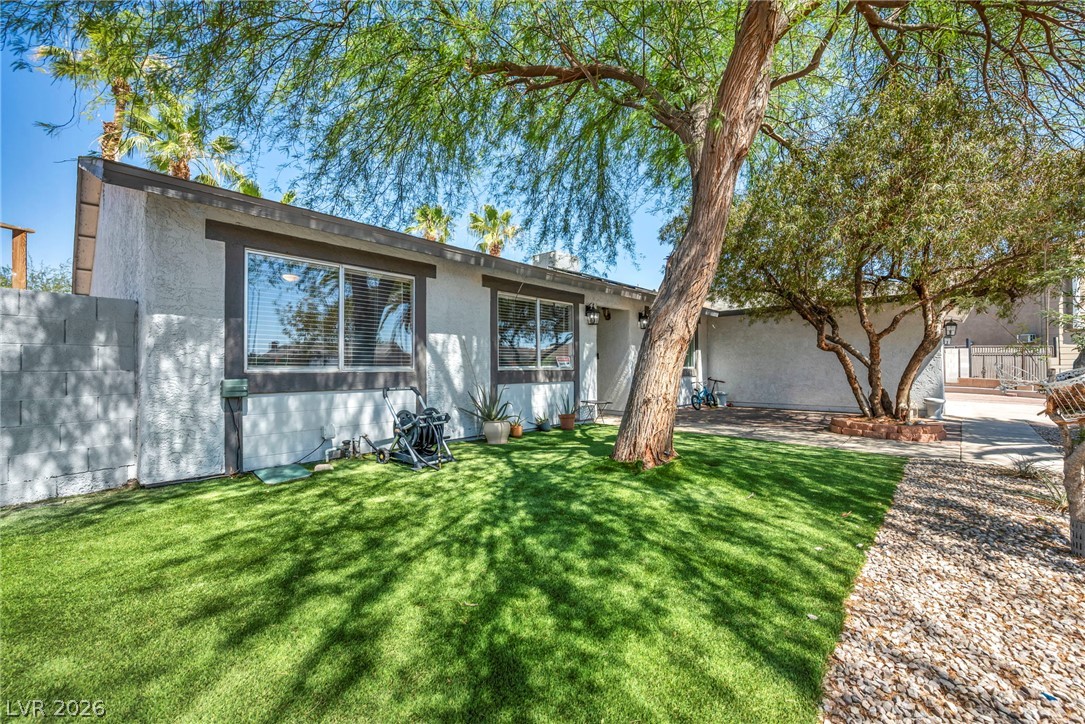 5882 Rio Tinto Way Las Vegas, NV 89110 - Photo 5 of 56 A vibrant green lawn and mature trees grace the welcoming exterior of this charming residence.