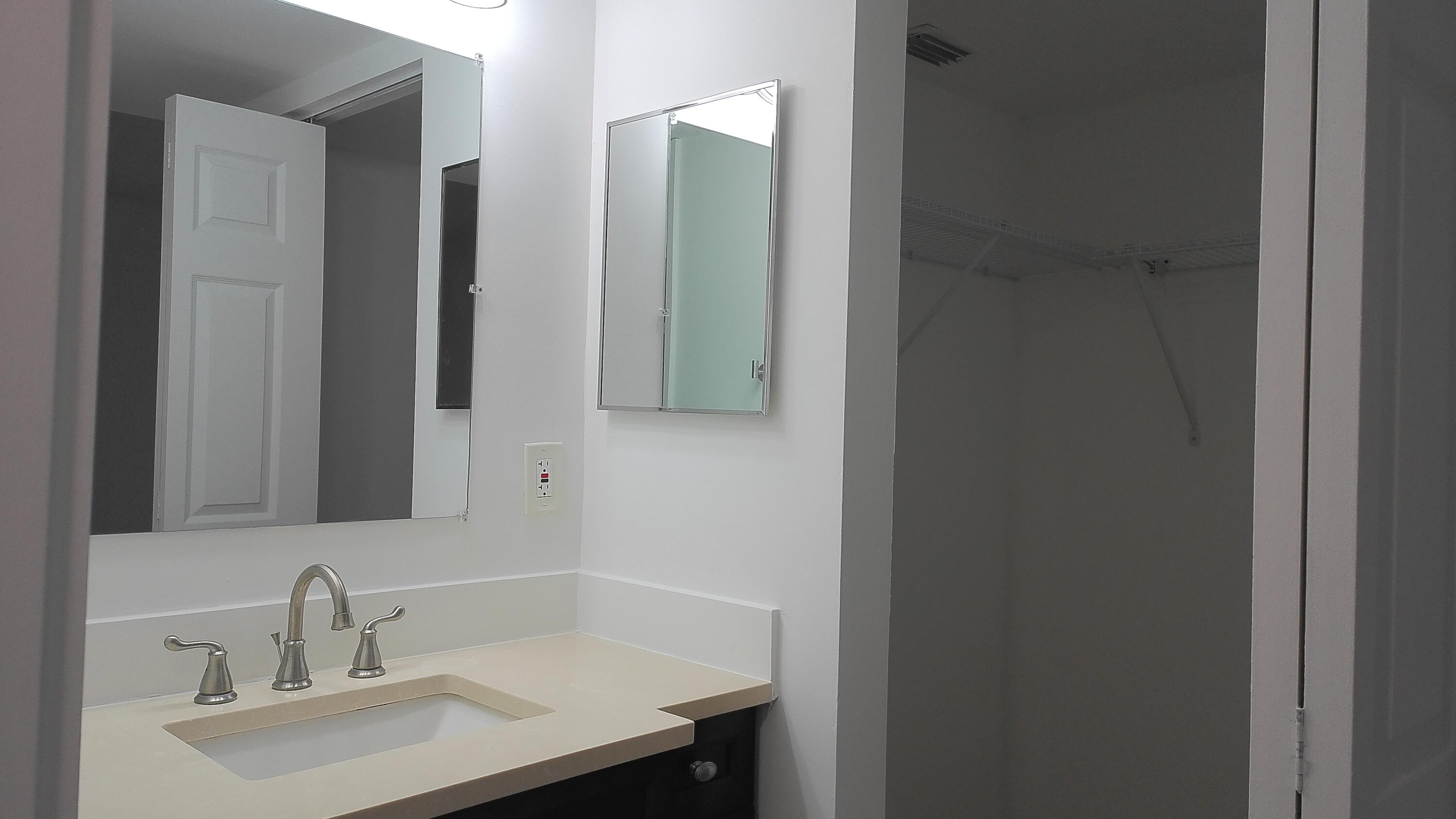 3180 Leewood Terrace, Unit L108 Boca Raton, FL 33431 - Photo 12 of 23 Vanity and Walk-in Closet