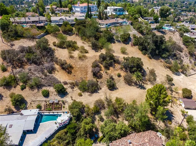 an aerial view of residential houses with city view