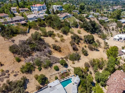 an aerial view of residential houses with city view