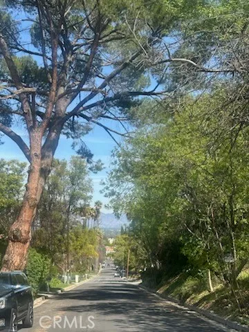 a view of a big yard with lots of green space