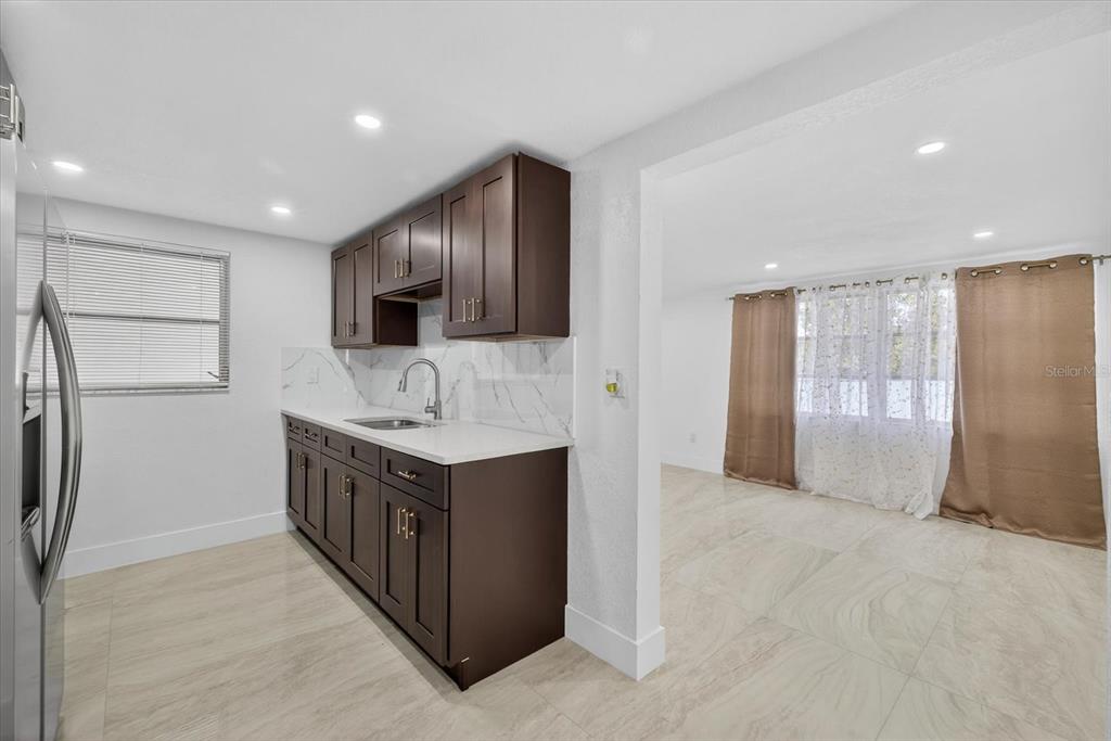 7421 Ashwood Drive Port Richey, FL 34668 - Photo 16 of 47 a kitchen with stainless steel appliances granite countertop a refrigerator and a sink