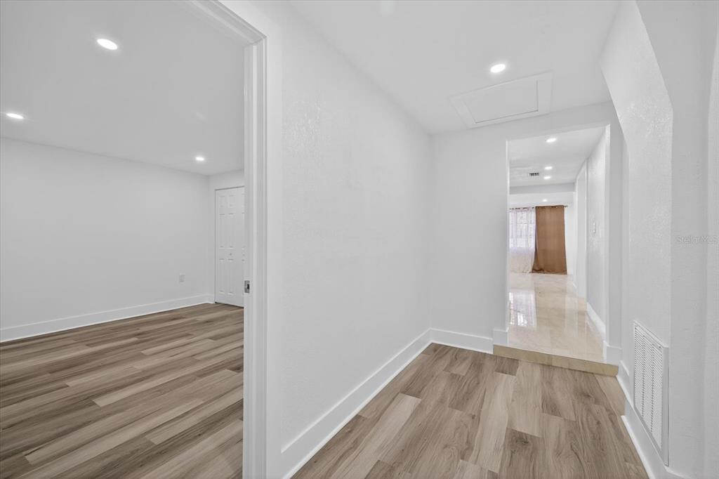 7421 Ashwood Drive Port Richey, FL 34668 - Photo 30 of 47 a view of room with window and wooden floor