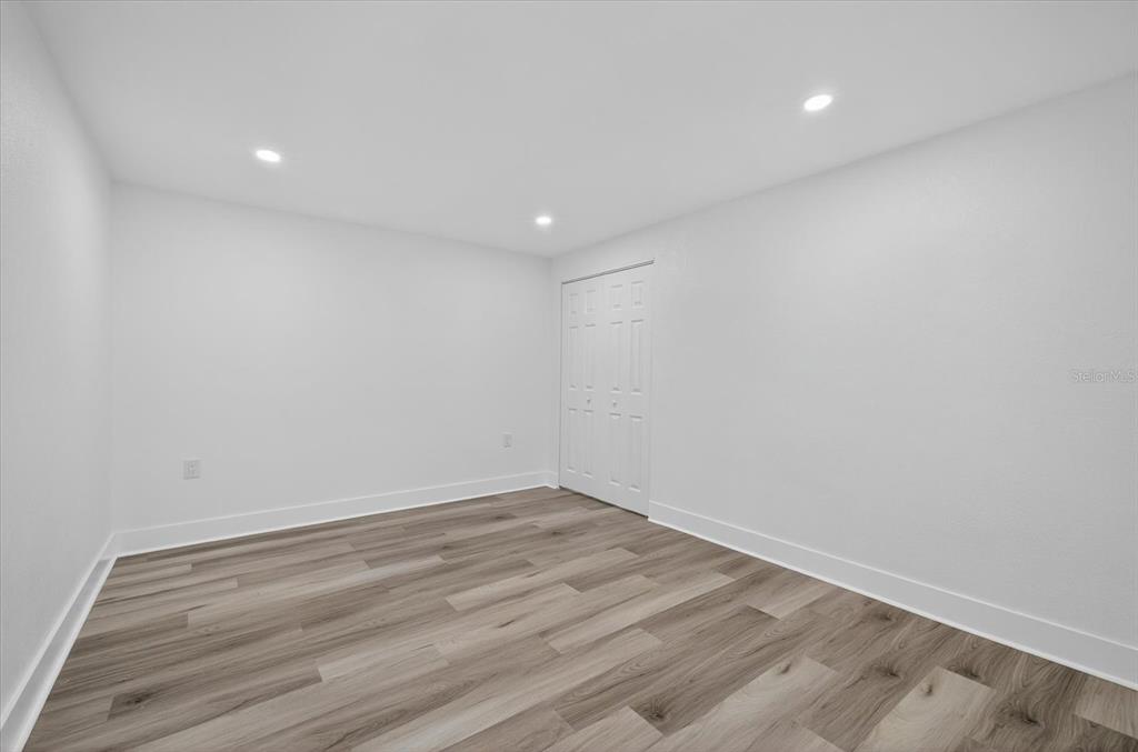 7421 Ashwood Drive Port Richey, FL 34668 - Photo 31 of 47 a view of room with wooden floor and fan