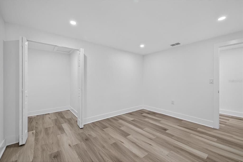 7421 Ashwood Drive Port Richey, FL 34668 - Photo 32 of 47 a view of room with wooden floor