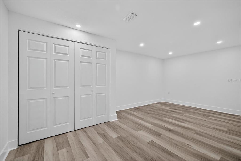 7421 Ashwood Drive Port Richey, FL 34668 - Photo 33 of 47 a view of empty room with wooden floor