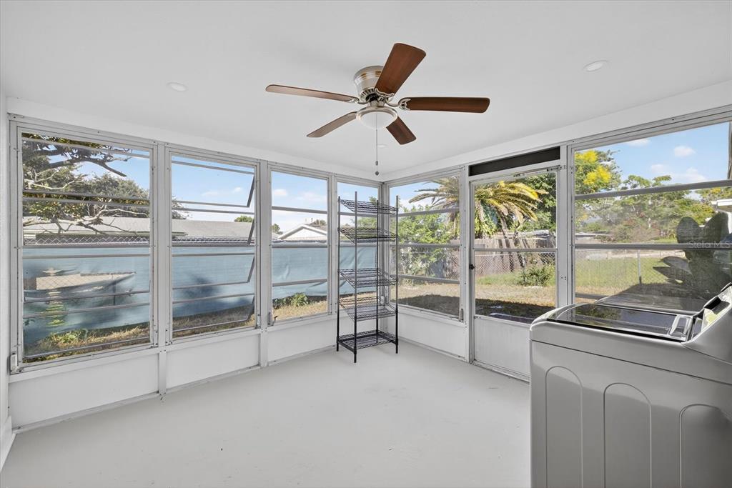 7421 Ashwood Drive Port Richey, FL 34668 - Photo 38 of 47 a view of a livingroom with a ceiling fan and a large window