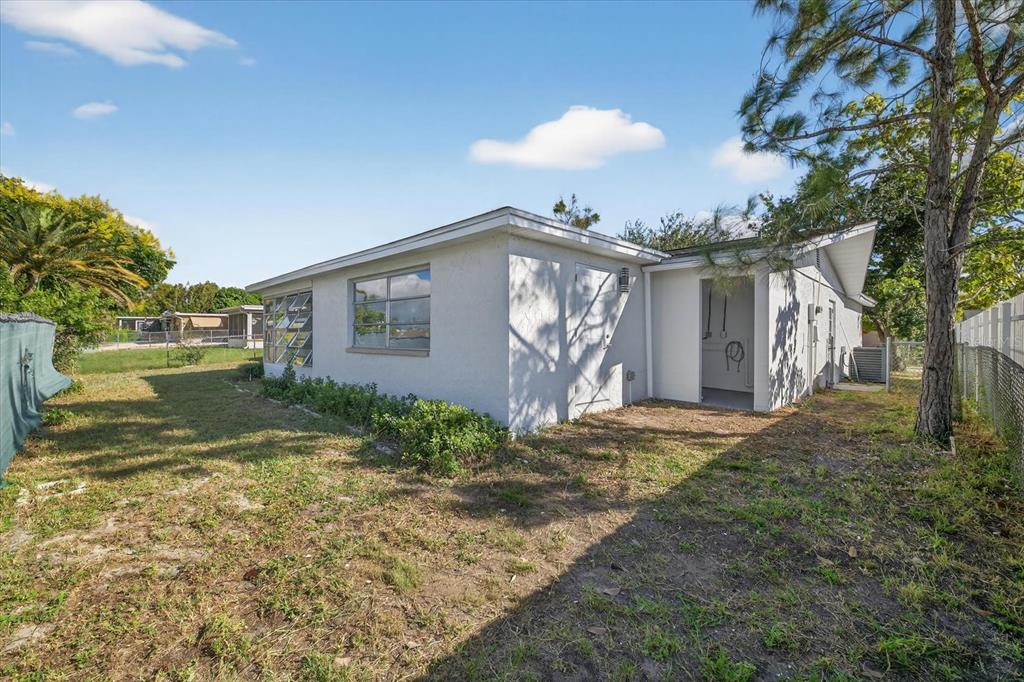7421 Ashwood Drive Port Richey, FL 34668 - Photo 40 of 47 a view of a house with a yard
