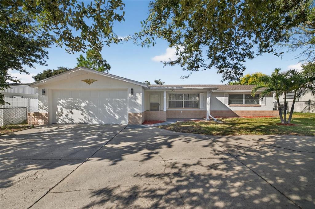 7421 Ashwood Drive Port Richey, FL 34668 - Photo 5 of 47 a view of a house with a yard and large tree